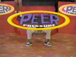 A person holding onto a hoop with the word peer pressure written on it.